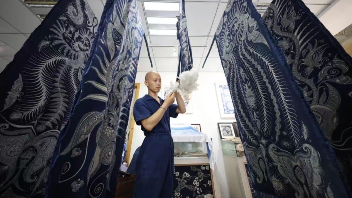 Miao women demonstrating traditional batik wax-resist dyeing in Danzhai