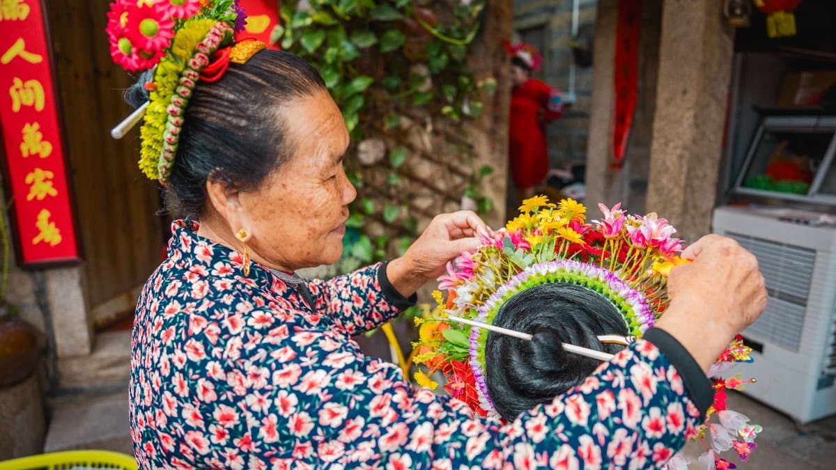 Xunpu village women wearing traditional zanhua flower crown headpieces